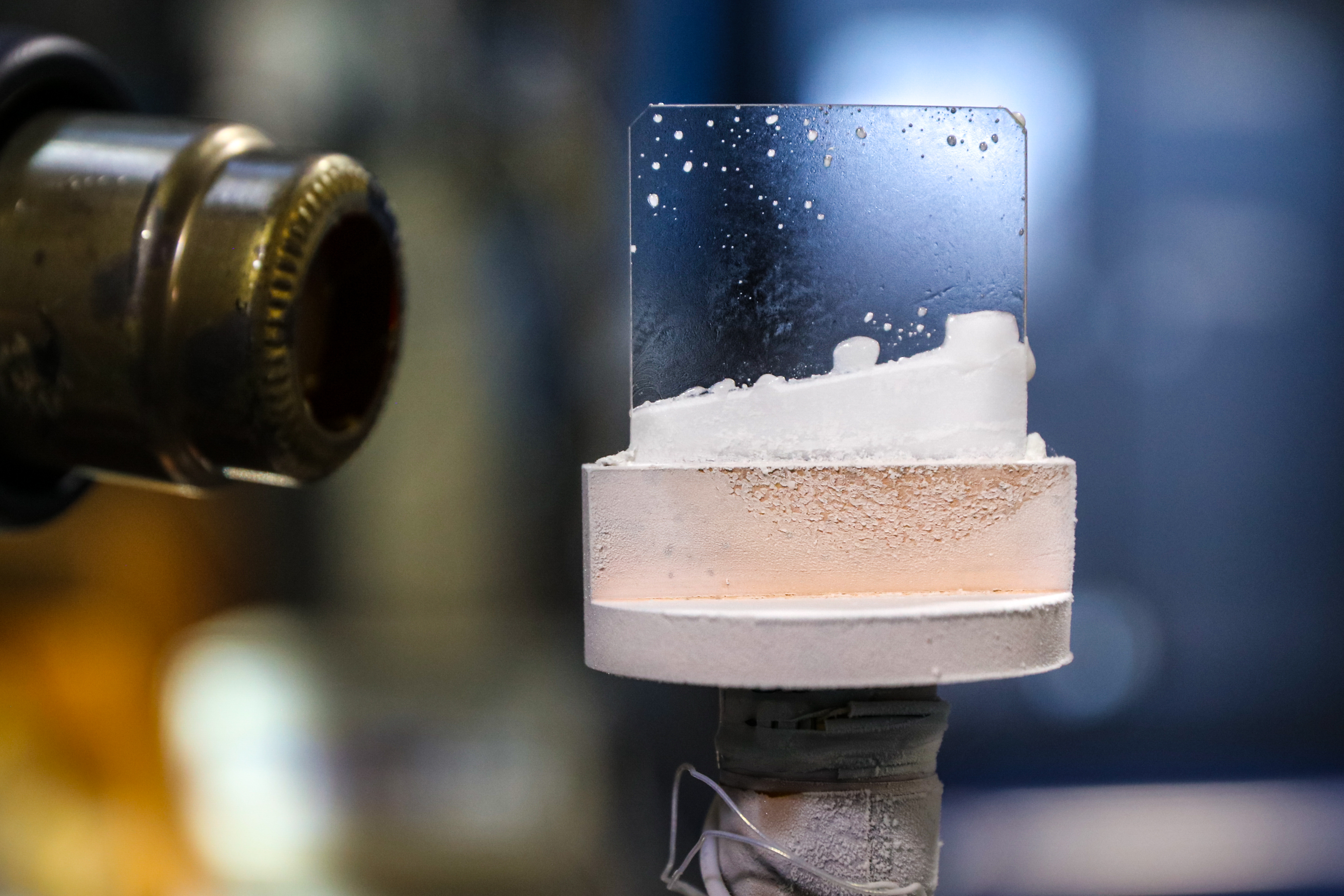 Scientists created this exotic “outer space” ice by freezing a stream of heavy water (D2O) molecules on a sapphire plate that is cooled to about -414° F in a vacuum chamber. Credit: ORNL/Genevieve Martin