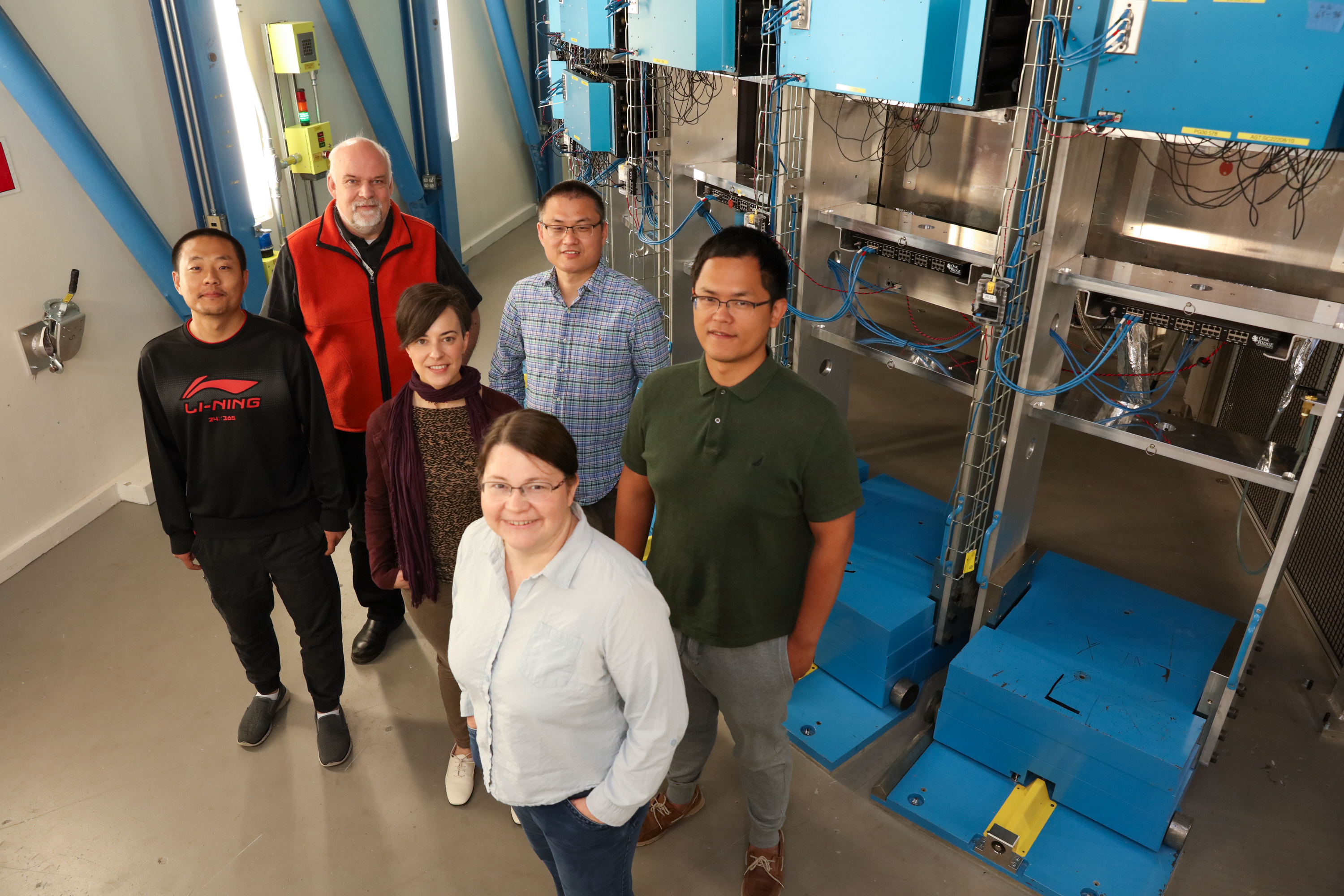 Powgen instrument team members standing inside the Powgen cave