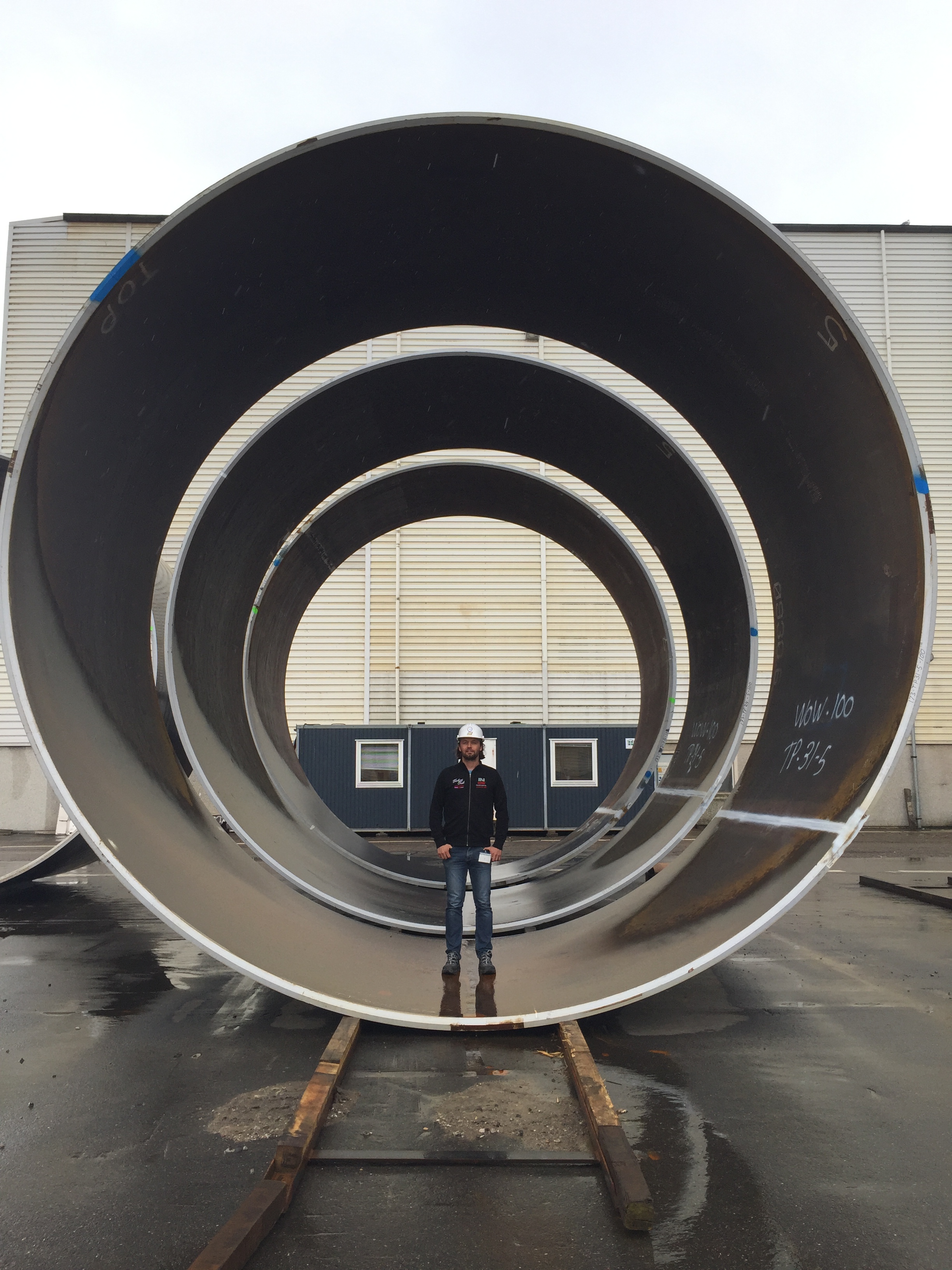 Andreassen demonstrates the enormity of each steel section used to build the monopile foundation in which circumferential welds are used to fuse them together. (Image credit: Louis Andersen)