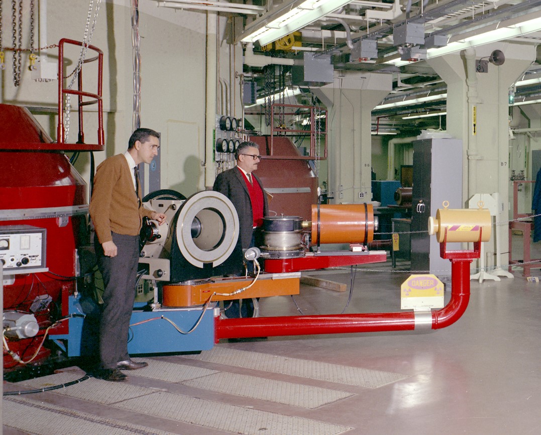 Ralph Moon (left) and Wallace Koehler next to the first polarized- neutron triple axis spectrometer at HFIR