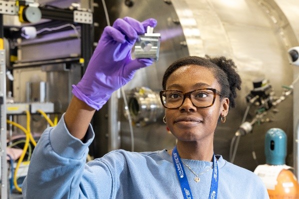 A HFIR user examines a sample prior to an experiment with neutrons