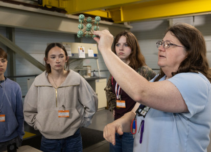 SNS scientific associate Melanie Kirkham shows Sophia and other Robertsville Middle School students a model of an atomic structure during their visit to the Spallation Neutron Source. Credit: Cindi Zdrinc/ORNL, U.S. Dept. of Energy