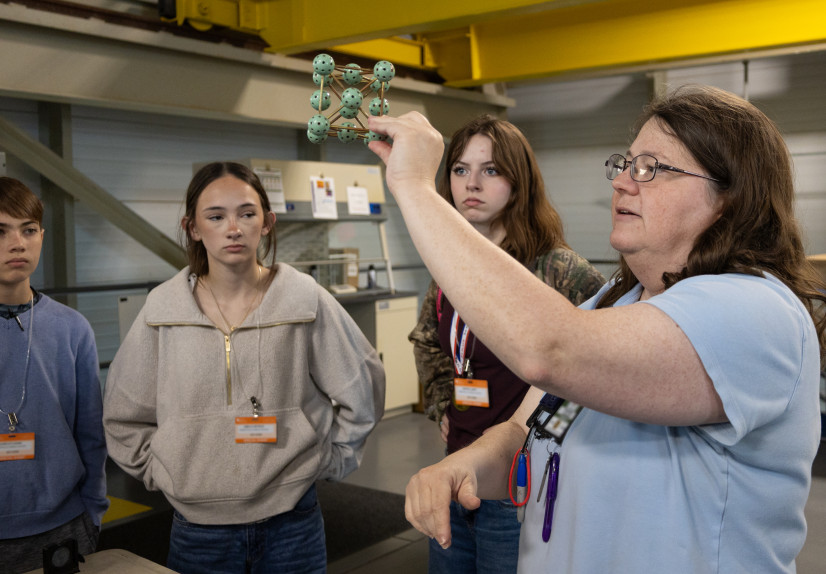 SNS scientific associate Melanie Kirkham shows Sophia and other Robertsville Middle School students a model of an atomic structure during their visit to the Spallation Neutron Source. Credit: Cindi Zdrinc/ORNL, U.S. Dept. of Energy
