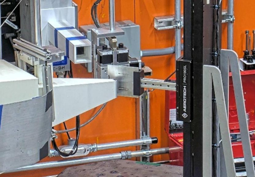 Large industrial neutron diffractometer inside a bright yellow and orange lab