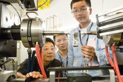 Dr. Dongchul Chae from POSCO, Yuan Li and Peijun Hou from the University of Tennessee, Knoxville, adjust a sample of stainless steel they are studying at VULCAN, SNS beam line 7. 