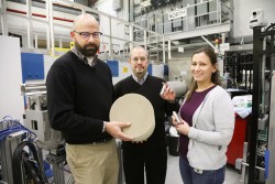 ORNL researchers Todd Toops, Charles Finney, and Melanie DeBusk (left to right) hold an example of a particulate filter used to collect harmful emissions in vehicles. Using neutrons, they are cultivating a better understanding of how heat treatments and oxidation methods can remove layers of soot and ash from these filters, which could lead to improved fuel efficiency. (Image credit: ORNL/Genevieve Martin) 