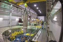 A heavy overhead crane is used to lower the 64,000-pound inner reflector plug into position, right in the heart of the Spallation Neutron Source. (image credit: ORNL/Genevieve Martin)