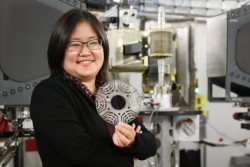 GE researcher Min Zou holds a metal laminate sheet made from a novel magnetic material used in a GE’s prototype synchronous reluctance motor. Credit: ORNL/Genevieve Martin