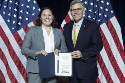 ORNL’s Kate Page, left, received a PECASE citation from Kelvin Droegemeier, Director of The White House Office of Science and Technology Policy. Credit: Donica Payne/U.S. Dept. of Energy