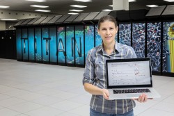 Ada Sedova, a postdoctoral research associate at the Oak Ridge Leadership Computing Facility (OLCF), develops computational calculations for supercomputing codes. In front of the OLCF’s Titan supercomputer, Sedova displays a spectrum from her experimental work, measuring the vibrational frequency of nucleobases (bases of DNA and RNA) at the Spallation Neutron Source, and complementary computational calculations.