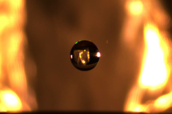 A small droplet of water is suspended in midair via an electrostatic levitator that lifts charged pa