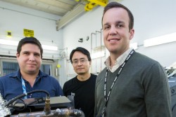 Researchers used neutrons to probe a running engine at ORNL’s Spallation Neutron Source, giving them the opportunity to test an aluminum-cerium alloy under operating conditions. From left, researchers Orlando Rios, Ke An, and Lt. Eric Stromme show off a cylinder head made from the new alloy. (Image credit: ORNL/Genevieve Martin)