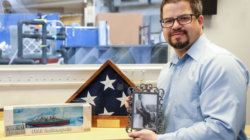 ORNL researcher Matt Stone keeps a scale model of the USS Indianapolis in his office as a tribute to his grandfather, who served aboard the ship during its top-secret mission to deliver weapons that would be used to end World War II. In its infancy, neutron scattering played a role in developing those weapons as part of Manhattan Project. Today, Stone uses neutrons to study materials that are used to improve life around the world. (credit: ORNL/Genevieve Martin)