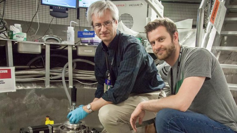Doug Abernathy, left, ARCS instrument scientist at Oak Ridge National Laboratory, and Marc Janoschek, Los Alamos National Laboratory, prepare their sample for experiments at the Spallation Neutron Source. Credit: Genevieve Martin/ORNL. 