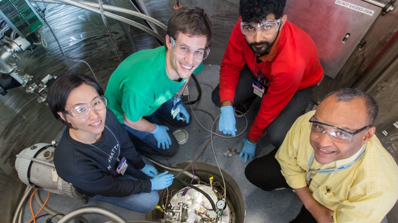 Sung Kim, Grayson Jackson and Ashish Jayaraman from the Univ. of Minnesota, and Souleymane Omar Diallo former BASIS instrument scientist, load a sample for an experiment on BASIS, SNS beam line 2. The team, led by Mahesh Mahanthappa is studying how nanoconfined water behaves in membranes, which could lead to the development of new ion transporting membranes in fuel cells and other electrochemical devices. Image credit: Genevieve Martin/ORNL