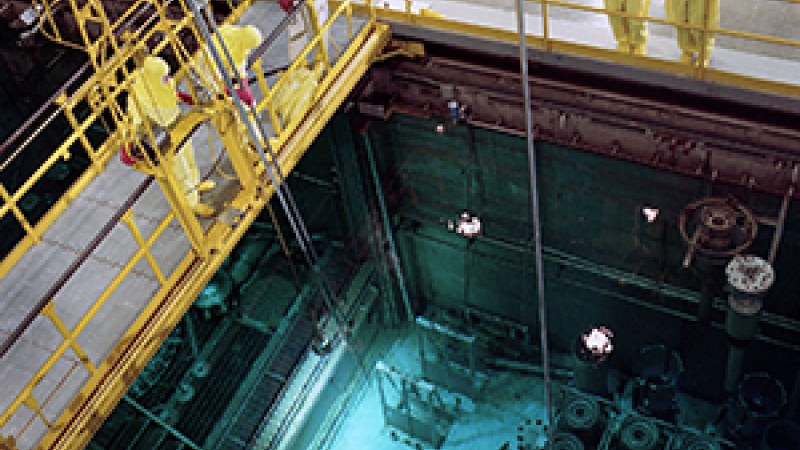 The High Flux Isotope Reactor vessel at Oak Ridge National Laboratory resides in a pool of water illuminated by the blue glow of the Cherenkov radiation effect.