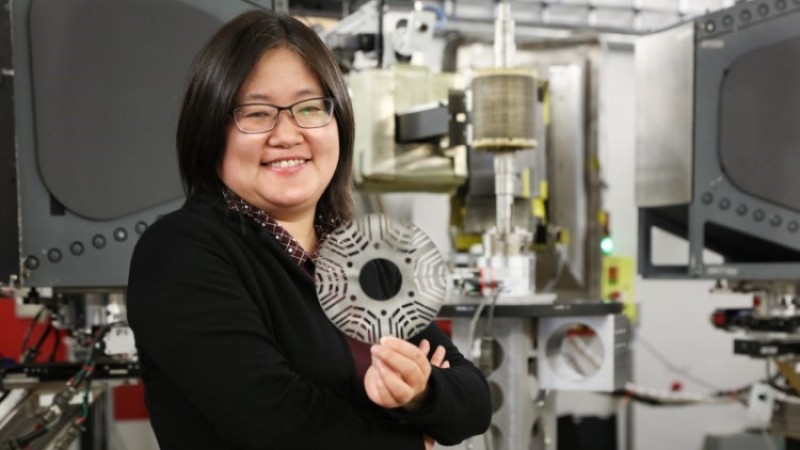 GE researcher Min Zou holds a metal laminate sheet made from a novel magnetic material used in a GE’s prototype synchronous reluctance motor. Credit: ORNL/Genevieve Martin