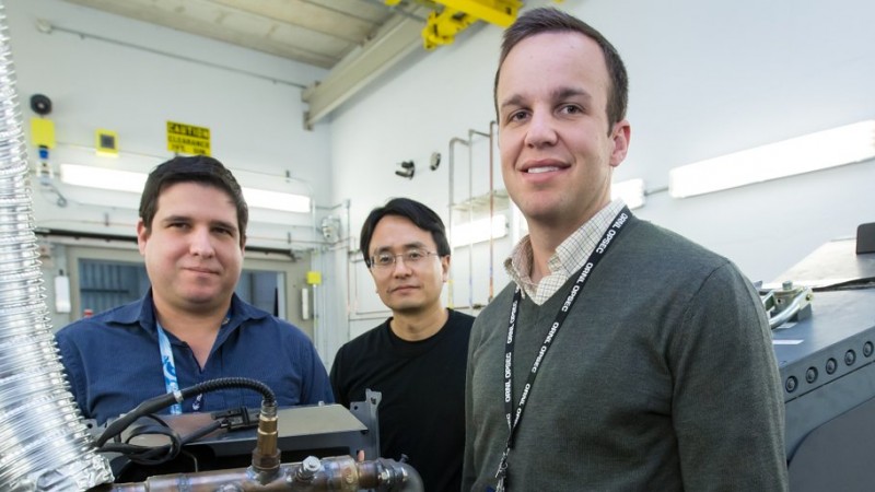 Researchers used neutrons to probe a running engine at ORNL’s Spallation Neutron Source, giving them the opportunity to test an aluminum-cerium alloy under operating conditions. From left, researchers Orlando Rios, Ke An, and Lt. Eric Stromme show off a cylinder head made from the new alloy. (Image credit: ORNL/Genevieve Martin)